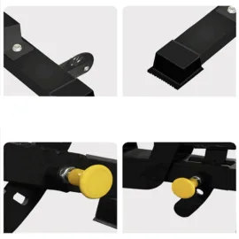 Close-up of black metal parts with yellow knobs on machinery.