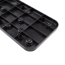 Black plastic tray with circular indentations and grid pattern.