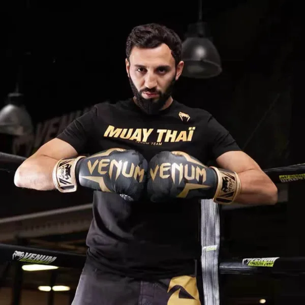 A boxer wearing a Venum boxing gloves - Black