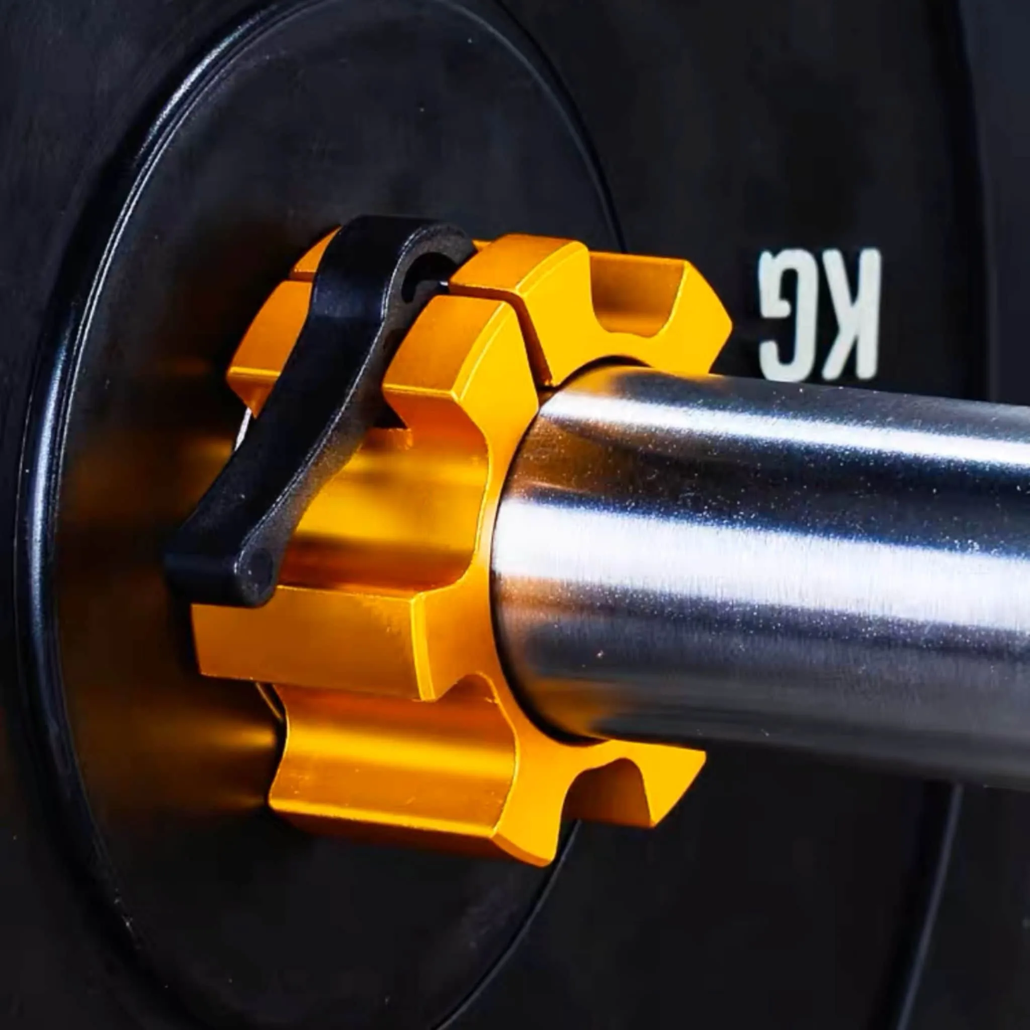 A yellow olympic barbell collar attached to a barbell sleeve