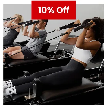 People training on Pilates reformer machines during 10% off studio promotion.