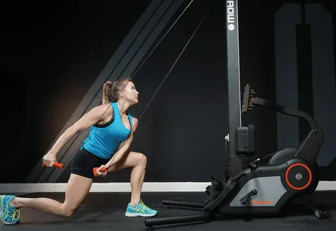 Woman exercising on rowing machine for full-body strength and cardio workout.